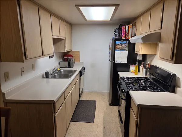 a kitchen with a sink stove and cabinets