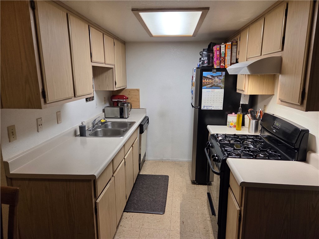633 North Street Corning, CA 96021 - Photo 11 of 26 a kitchen with a sink stove and cabinets