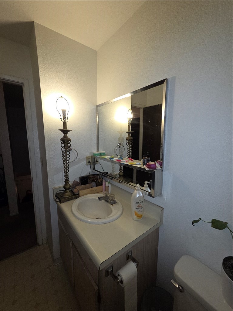 633 North Street Corning, CA 96021 - Photo 18 of 26 a bathroom with a sink toilet and mirror