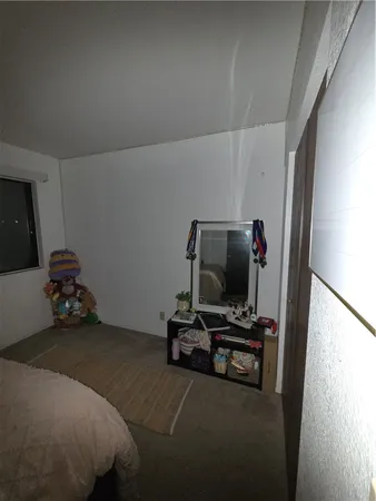 a bedroom with a bed and gym equipment