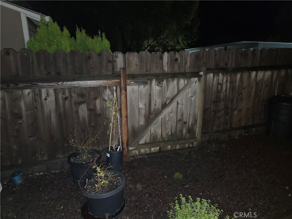 633 North Street Corning, CA 96021 - Photo 24 of 26 a wooden fence with some plants in front of house