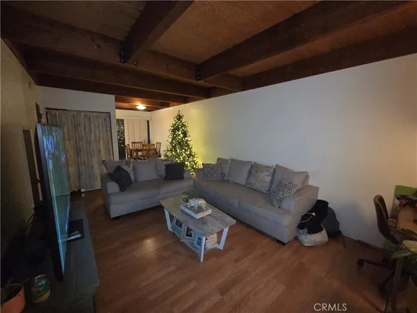 a living room with furniture window and a wooden floor