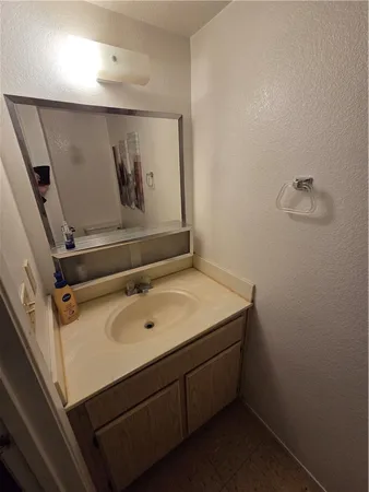 a bathroom with a sink and mirror