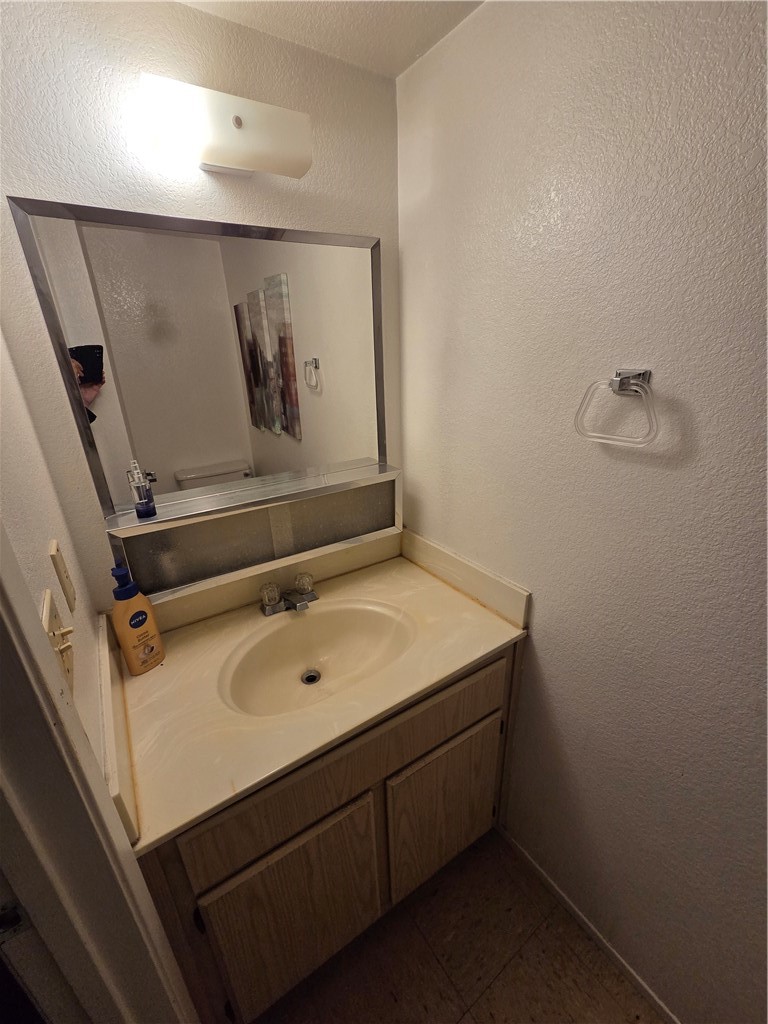 633 North Street Corning, CA 96021 - Photo 7 of 26 a bathroom with a sink and mirror