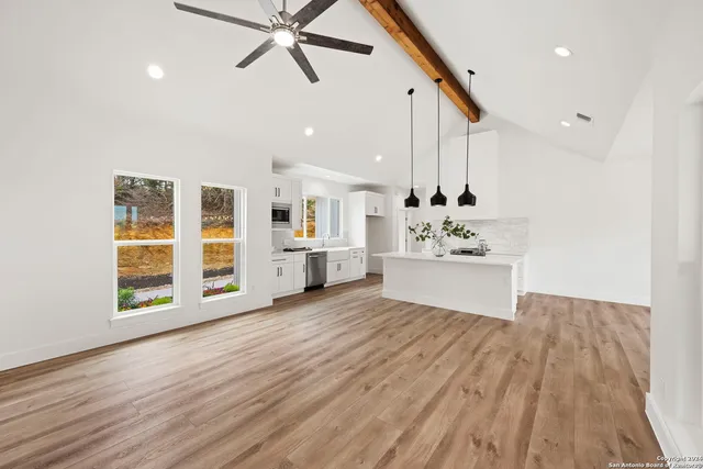 a view of a kitchen with a sink and cabinet with wooden floor