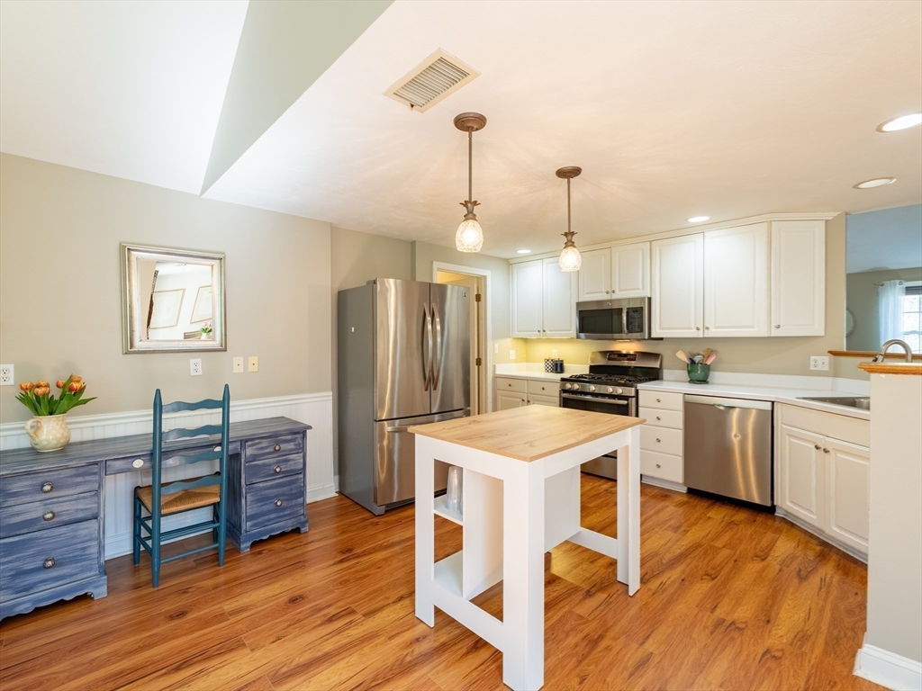67 Tussock Brook Road, Unit 67 Duxbury, MA 02332 - Photo 11 of 39 a kitchen with granite countertop a center island a counter space stainless steel appliances and cabinets