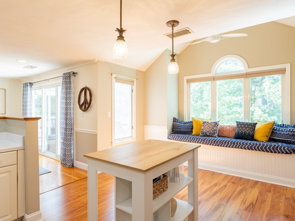 67 Tussock Brook Road, Unit 67 Duxbury, MA 02332 - Photo 12 of 39 a living room with a couch and a chandelier