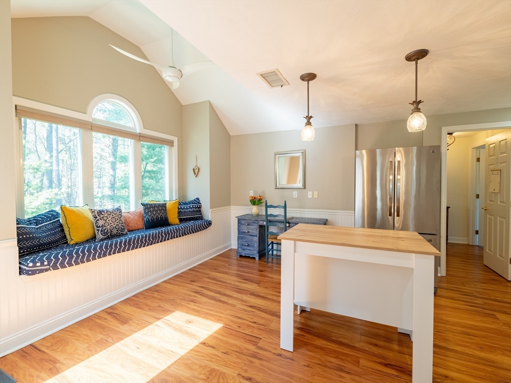 67 Tussock Brook Road, Unit 67 Duxbury, MA 02332 - Photo 13 of 39 a living room with a couch wooden floor and a chandelier