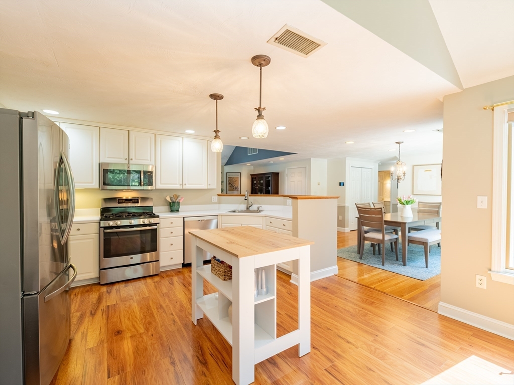 67 Tussock Brook Road, Unit 67 Duxbury, MA 02332 - Photo 14 of 39 a large kitchen with a center island and stainless steel appliances
