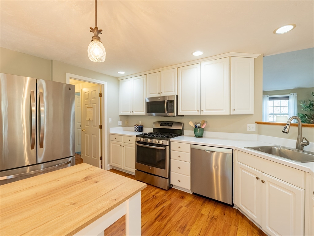 67 Tussock Brook Road, Unit 67 Duxbury, MA 02332 - Photo 15 of 39 a kitchen with stainless steel appliances granite countertop a sink stove and refrigerator