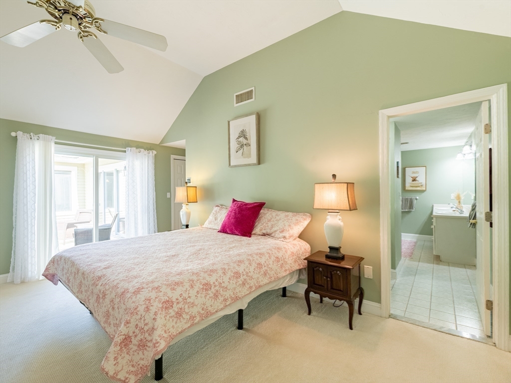 67 Tussock Brook Road, Unit 67 Duxbury, MA 02332 - Photo 18 of 39 a bedroom with a bed and a table