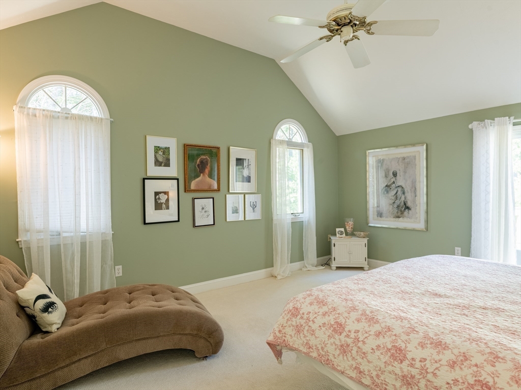 67 Tussock Brook Road, Unit 67 Duxbury, MA 02332 - Photo 19 of 39 a bedroom with a bed and a chandelier