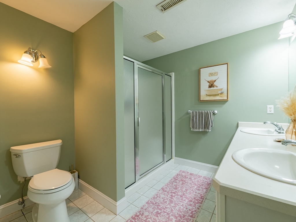 67 Tussock Brook Road, Unit 67 Duxbury, MA 02332 - Photo 21 of 39 a bathroom with a sink and a toilet