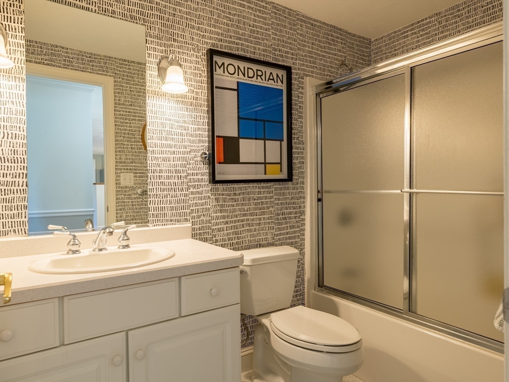 67 Tussock Brook Road, Unit 67 Duxbury, MA 02332 - Photo 22 of 39 a bathroom with a sink a toilet and shower