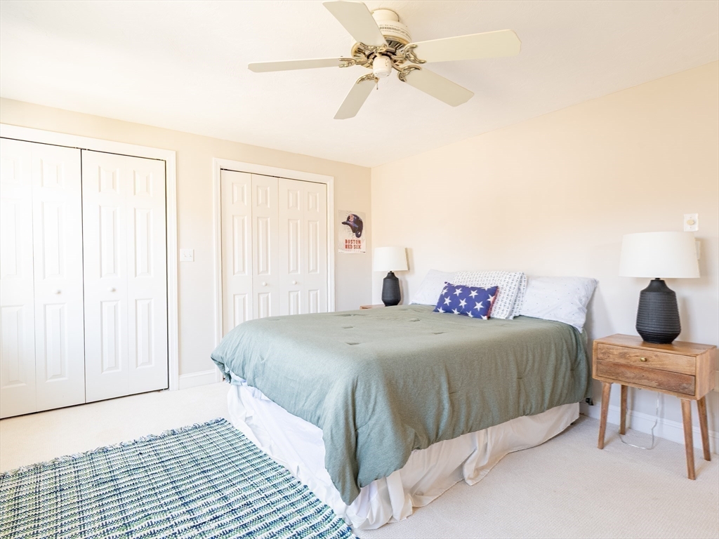 67 Tussock Brook Road, Unit 67 Duxbury, MA 02332 - Photo 23 of 39 a bedroom with a bed and cabinets