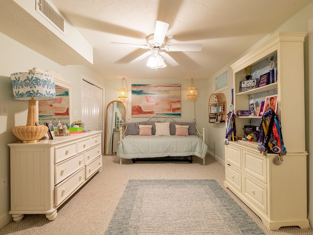 67 Tussock Brook Road, Unit 67 Duxbury, MA 02332 - Photo 26 of 39 a living room with furniture and a chandelier