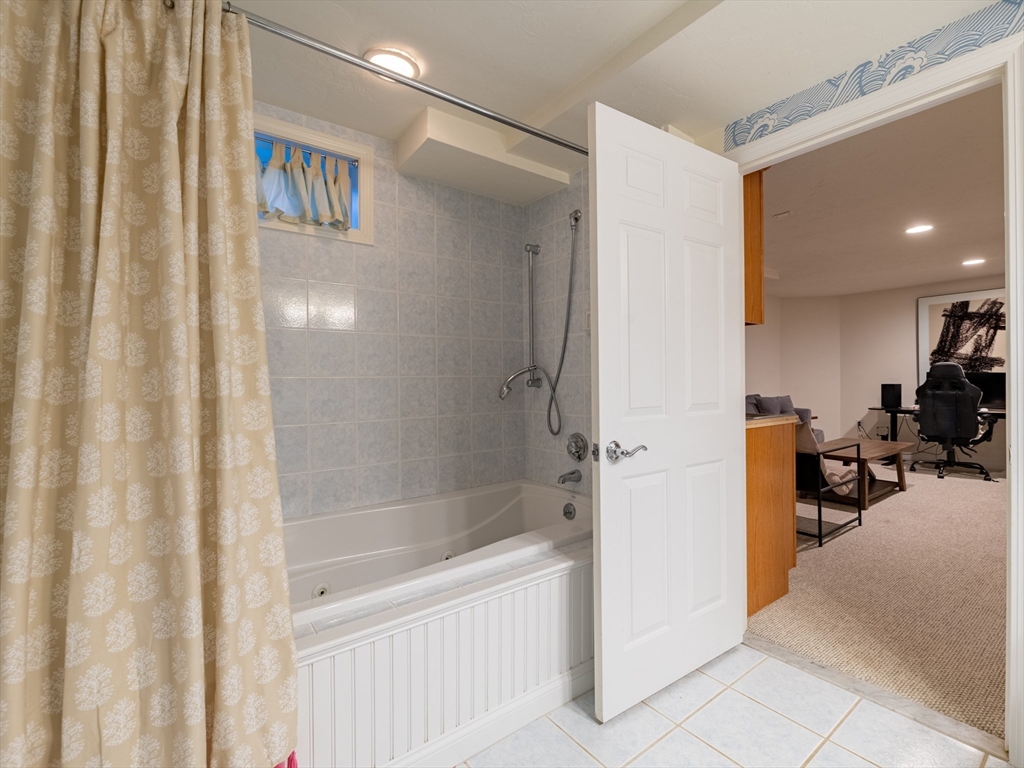 67 Tussock Brook Road, Unit 67 Duxbury, MA 02332 - Photo 30 of 39 a bathroom with a bathtub and a shower