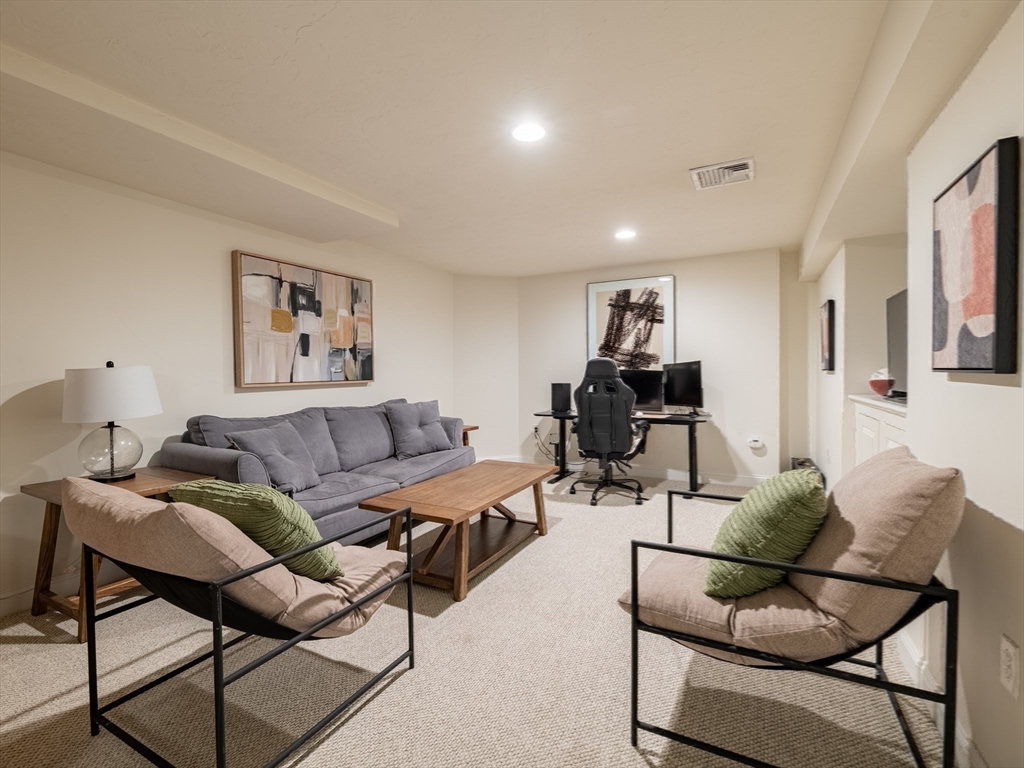 67 Tussock Brook Road, Unit 67 Duxbury, MA 02332 - Photo 31 of 39 a living room with furniture and wooden floor