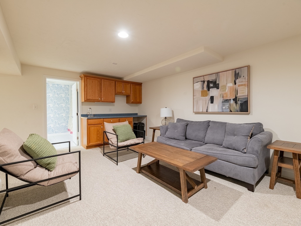 67 Tussock Brook Road, Unit 67 Duxbury, MA 02332 - Photo 33 of 39 a living room with furniture and a couch