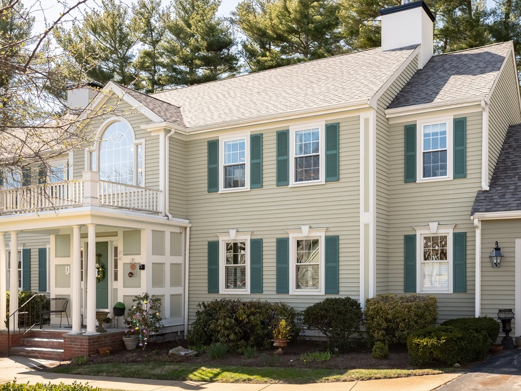 67 Tussock Brook Road, Unit 67 Duxbury, MA 02332 - Photo 36 of 39 a front view of a residential houses with yard and retail shops