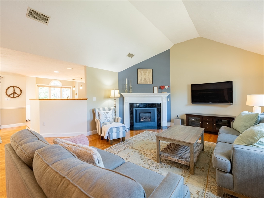 67 Tussock Brook Road, Unit 67 Duxbury, MA 02332 - Photo 5 of 39 a living room with furniture and a fireplace