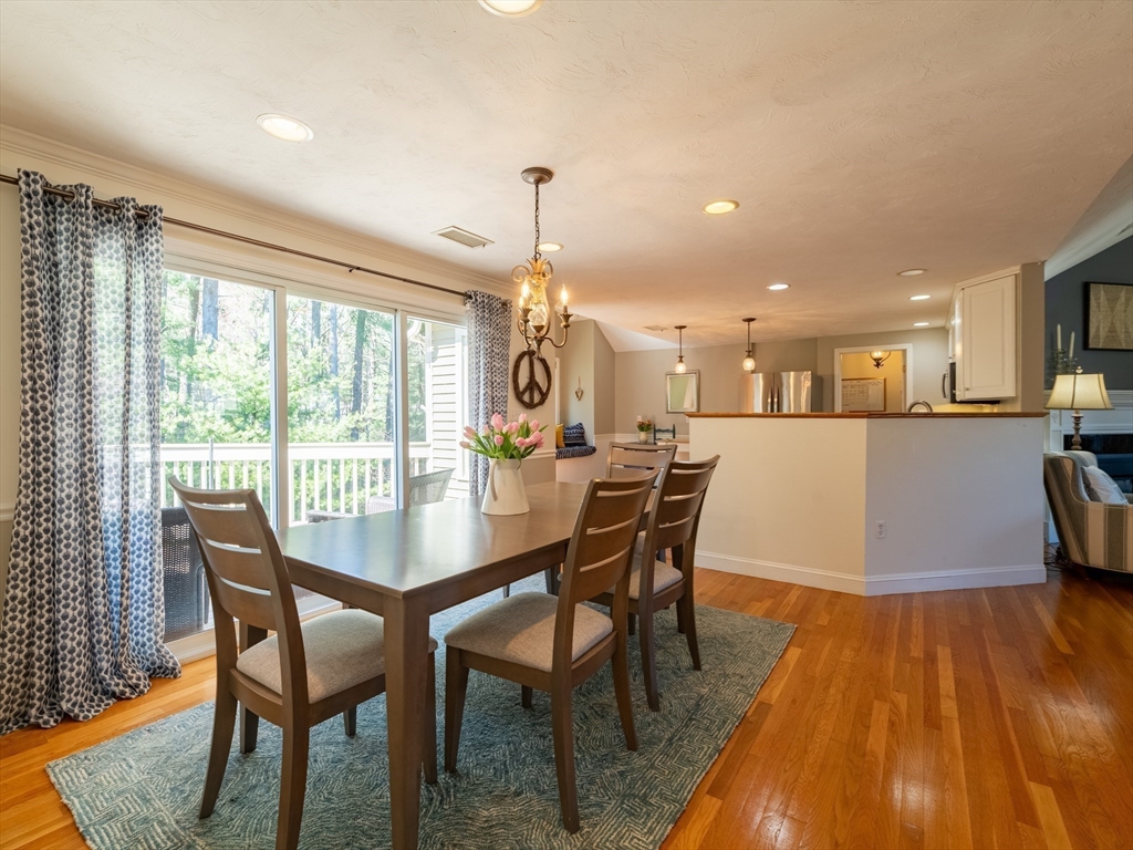 67 Tussock Brook Road, Unit 67 Duxbury, MA 02332 - Photo 7 of 39 a dining room with furniture and wooden floor