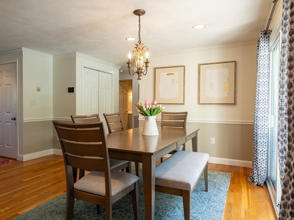 67 Tussock Brook Road, Unit 67 Duxbury, MA 02332 - Photo 10 of 39 a view of a dining room with furniture and wooden floor