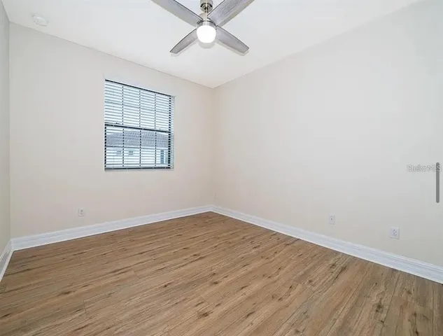 a bathroom with a granite countertop sink a toilet and a bathtub