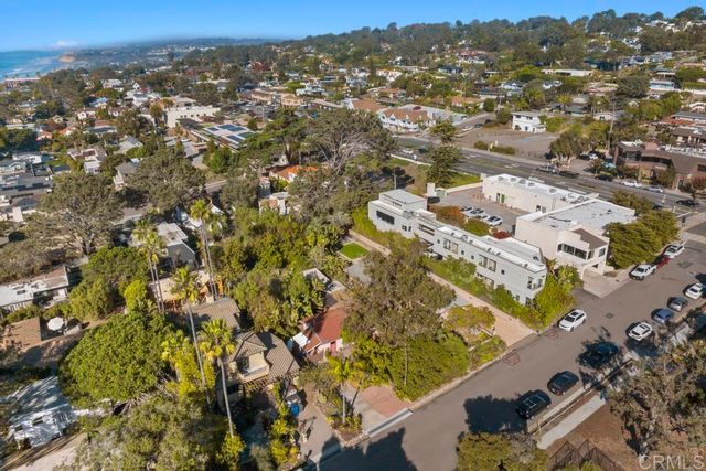 an aerial view of residential houses with yard