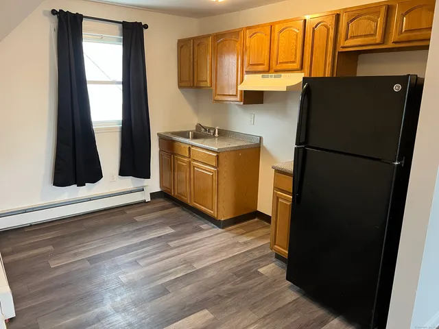 a kitchen with a refrigerator and a window