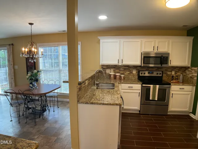 a living room with patio furniture and a fireplace