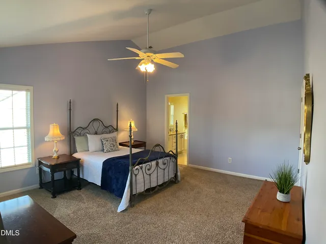 a bedroom with a bed dresser and a window