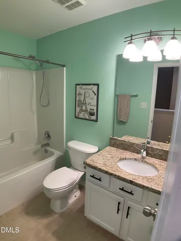 a bedroom with a bed chairs and window