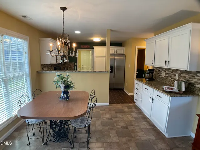 a kitchen with stainless steel appliances granite countertop a refrigerator stove microwave and sink