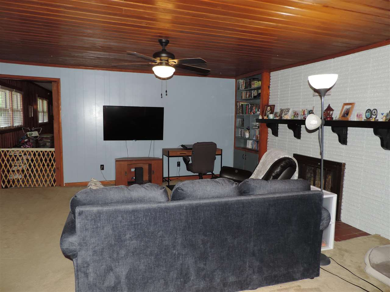 150 Tatum Street Ridgely, TN 38080 - Photo 10 of 17 a projector room with fireplace furniture and a flat screen tv