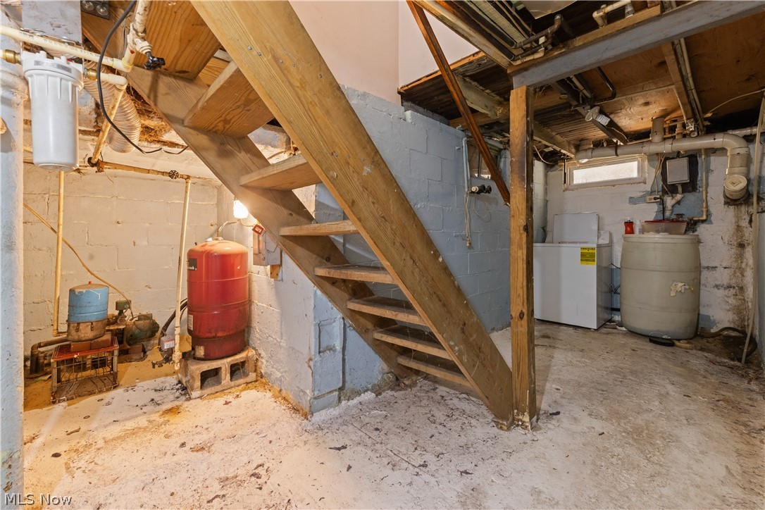 409 Edith Avenue Akron, OH 44312 - Photo 26 of 45 Basement space featuring a wooden staircase, concrete block walls, and exposed utility infrastructure