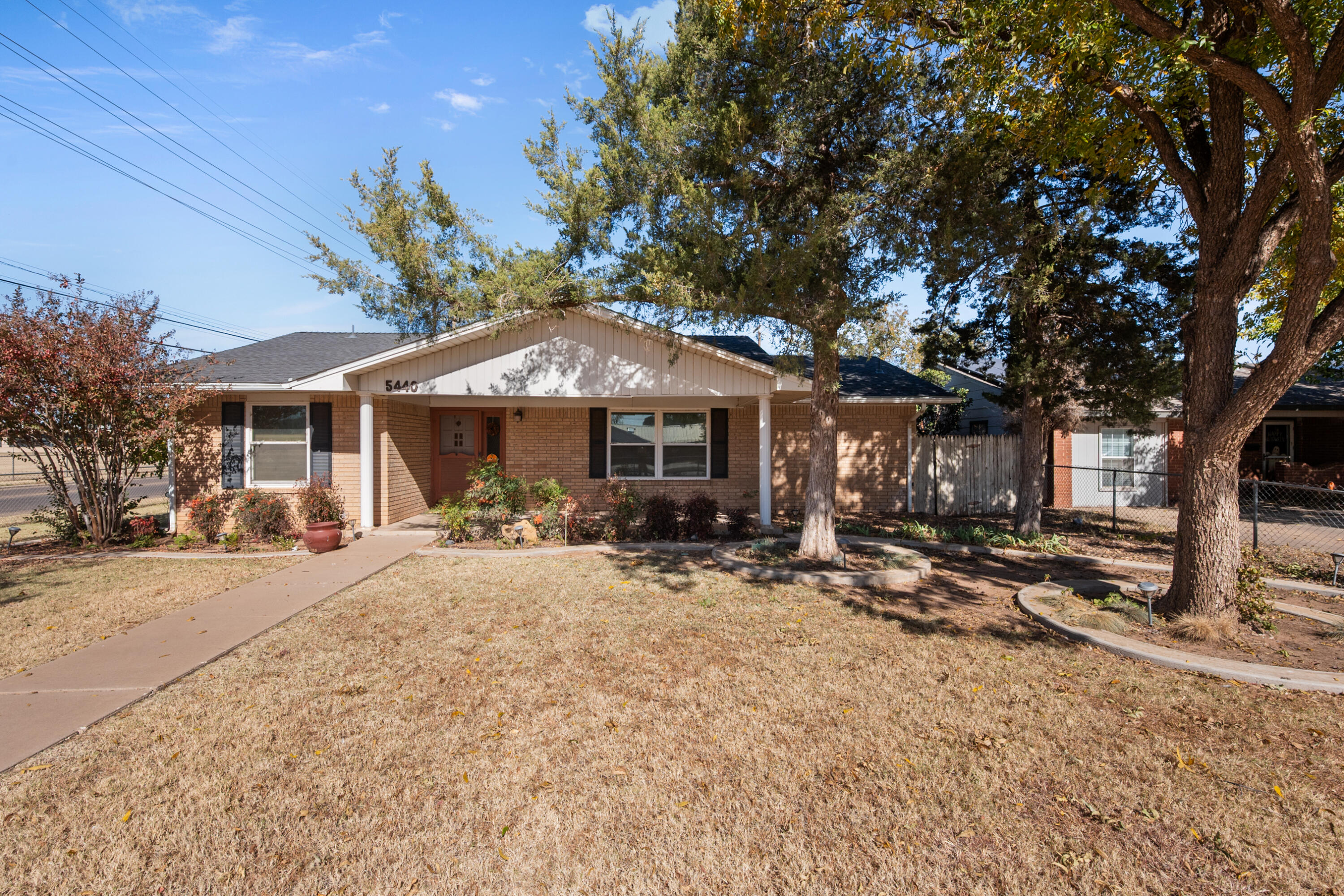5440 48th Street Lubbock, TX 79414 - Photo 1 of 28 a patio with a table and chairs under an umbrella