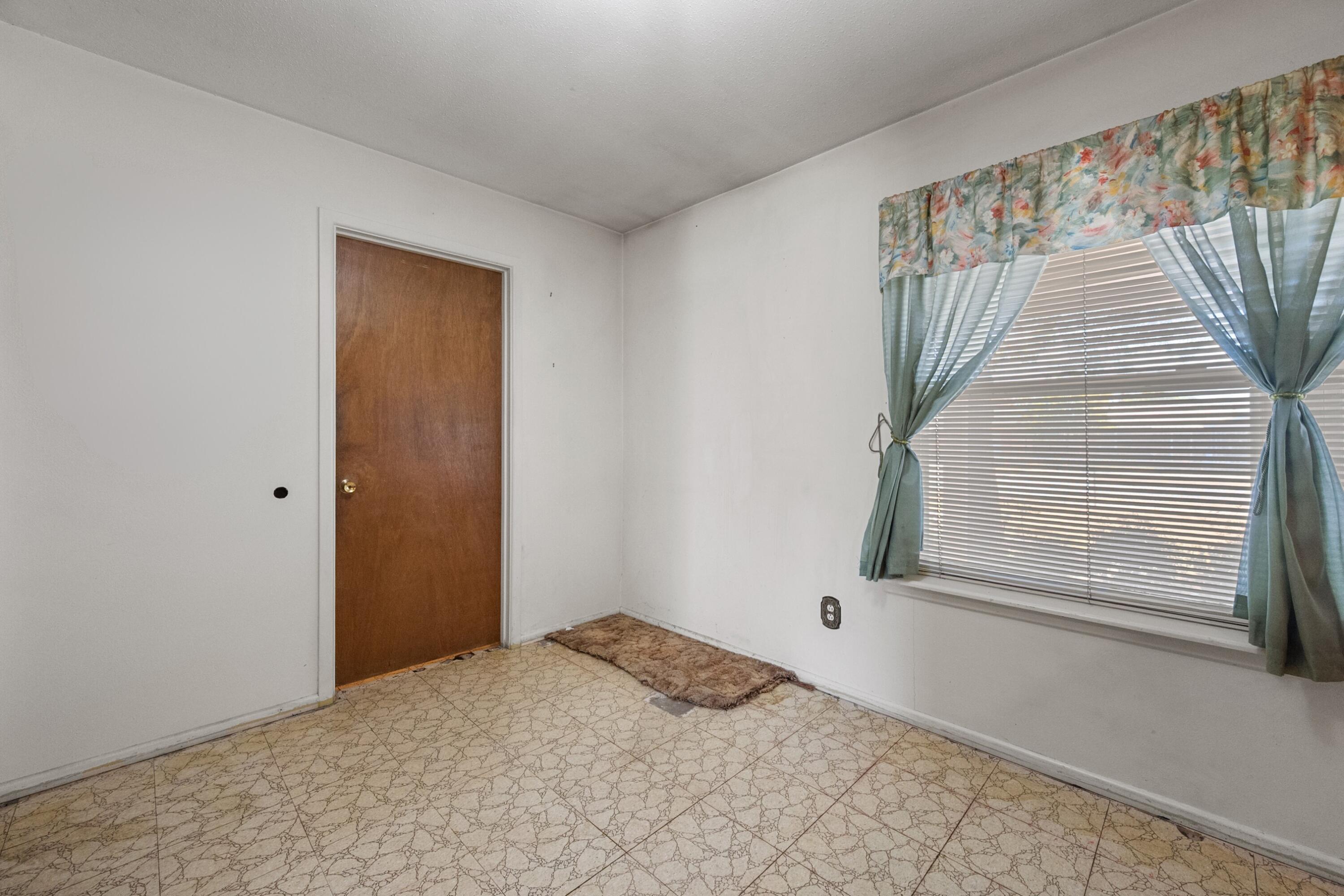 5440 48th Street Lubbock, TX 79414 - Photo 13 of 28 a view of a livingroom with an empty space and a window
