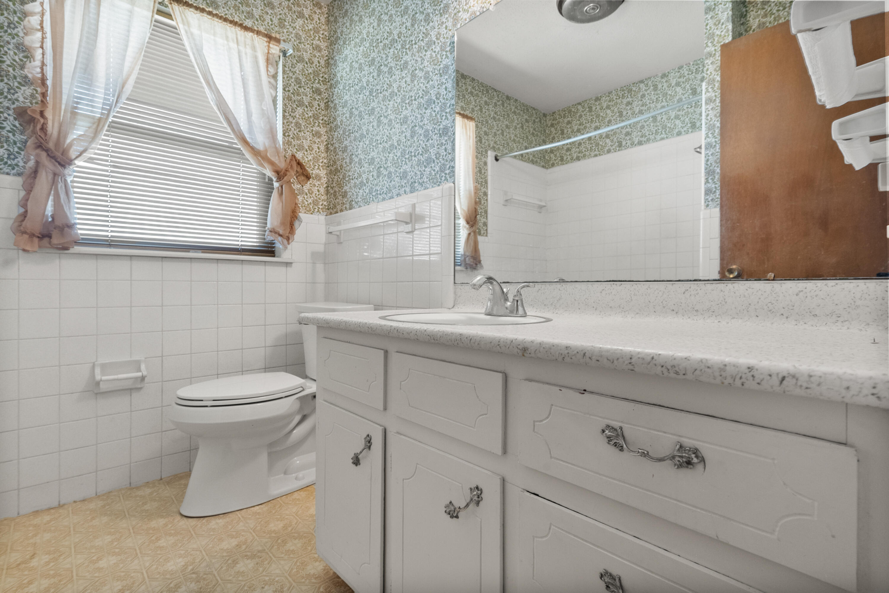 5440 48th Street Lubbock, TX 79414 - Photo 21 of 28 a bathroom with a toilet sink and mirror