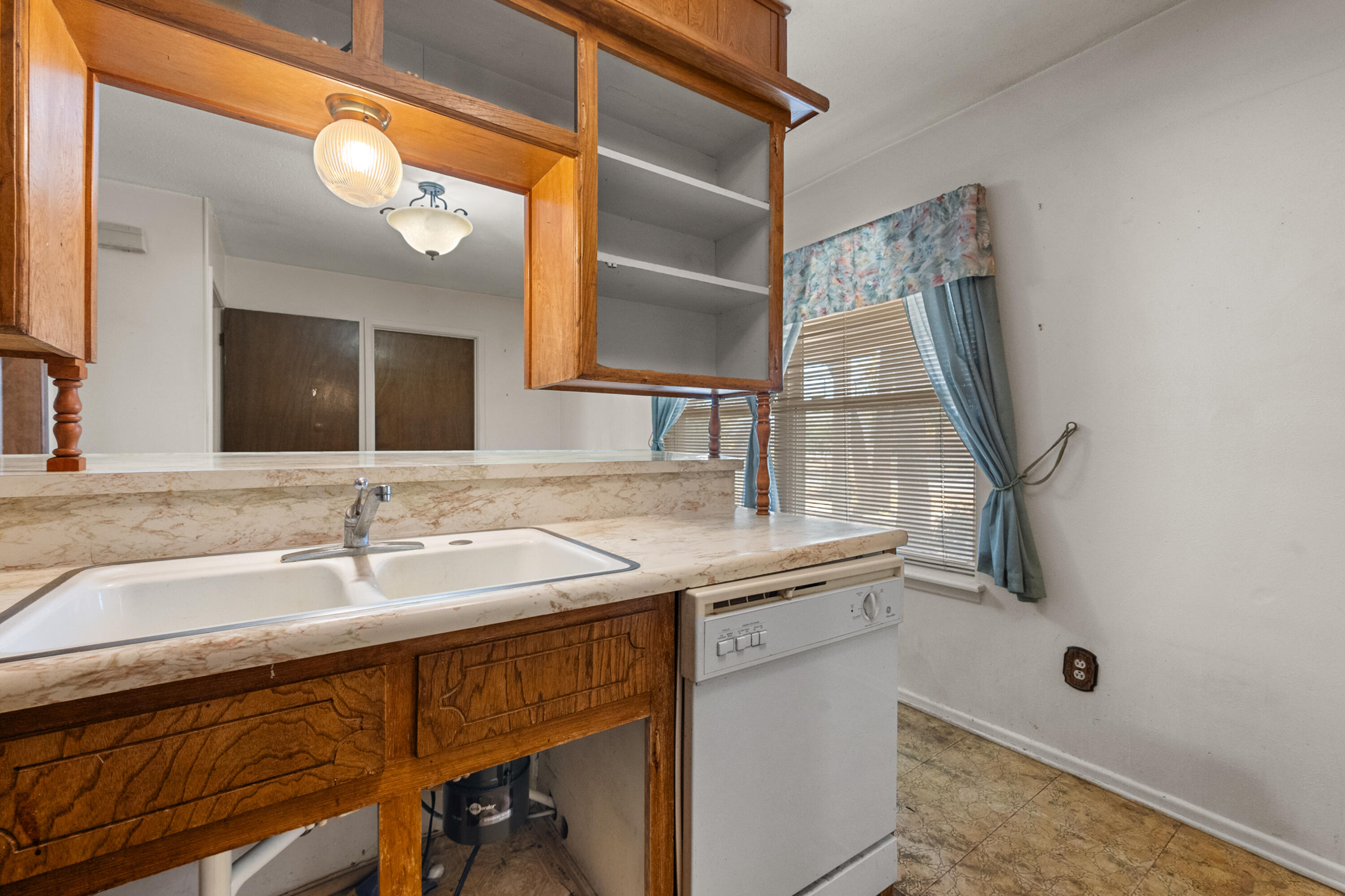 5440 48th Street Lubbock, TX 79414 - Photo 9 of 28 a bathroom with a sink and a mirror