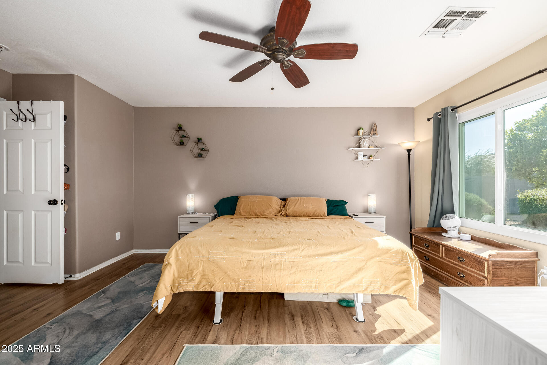 1675 East Robin Lane Gilbert, AZ 85296 - Photo 11 of 29 a bedroom with a bed and wooden floor