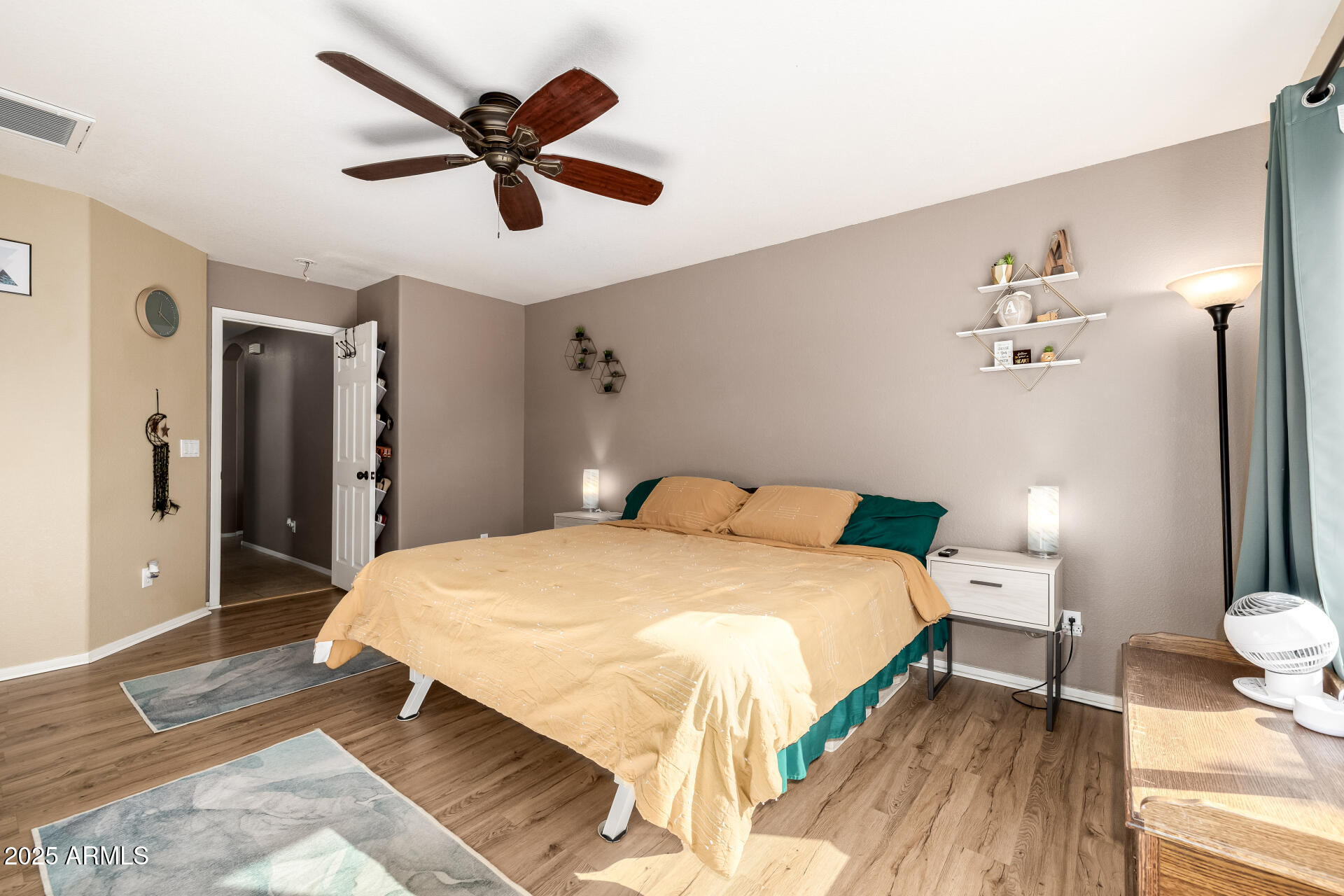 1675 East Robin Lane Gilbert, AZ 85296 - Photo 12 of 29 a spacious bedroom with a bed and a ceiling fan