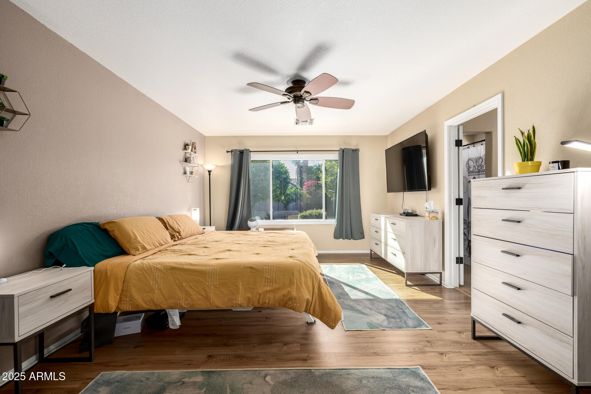 1675 East Robin Lane Gilbert, AZ 85296 - Photo 13 of 29 a bedroom with a bed and a flat screen tv