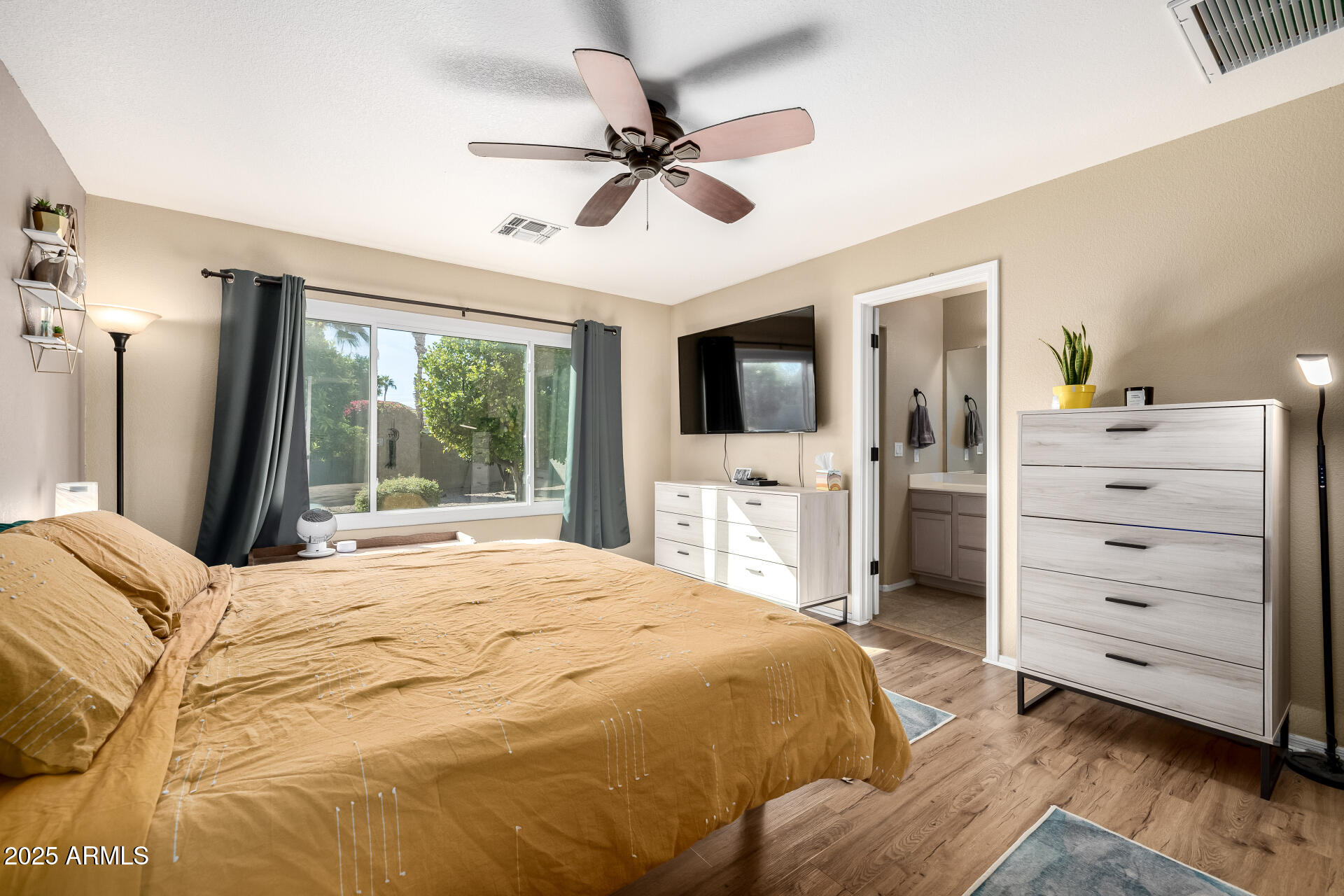 1675 East Robin Lane Gilbert, AZ 85296 - Photo 14 of 29 a bedroom with a bed and a flat screen tv