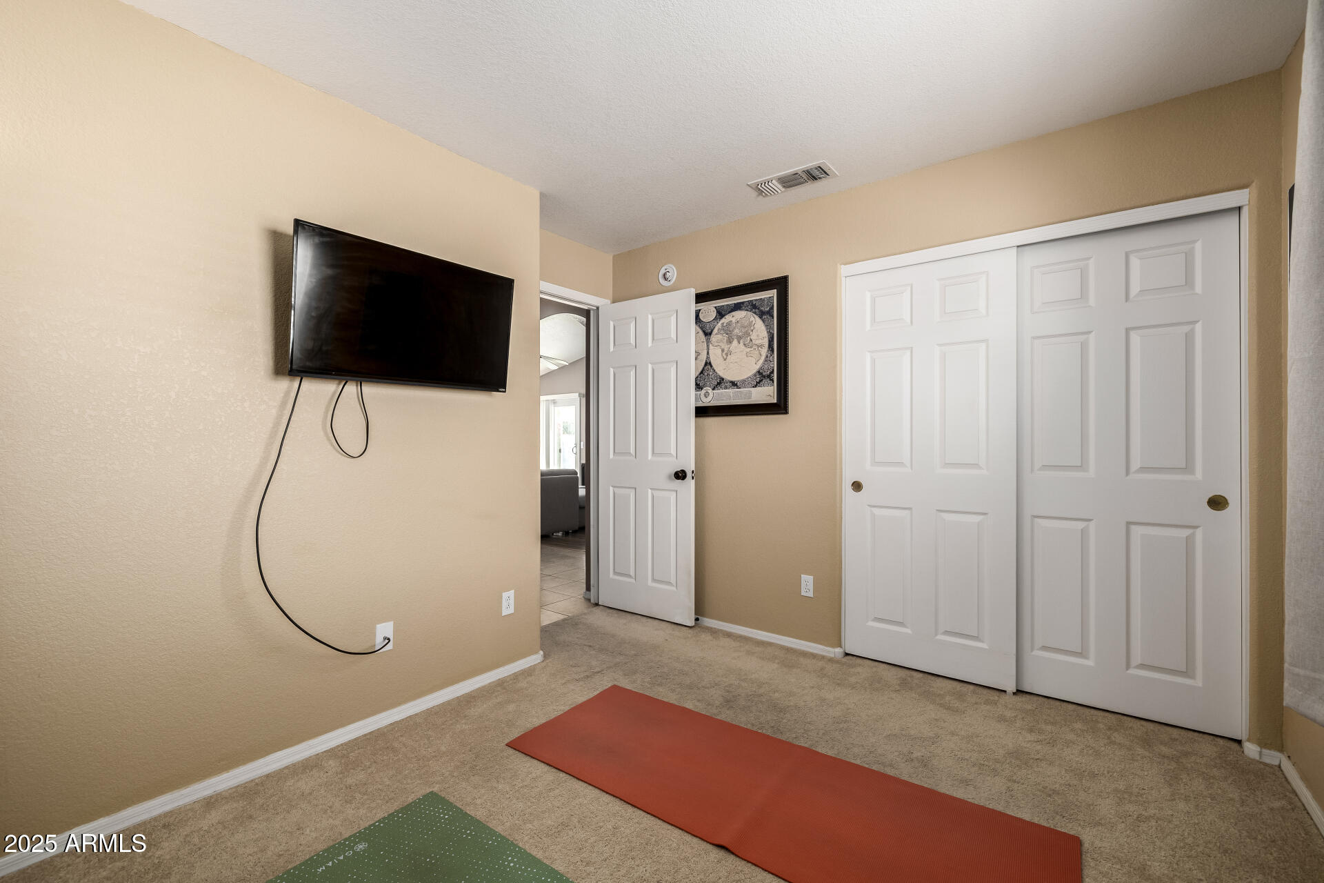 1675 East Robin Lane Gilbert, AZ 85296 - Photo 20 of 29 a bedroom with a bed and a flat screen tv