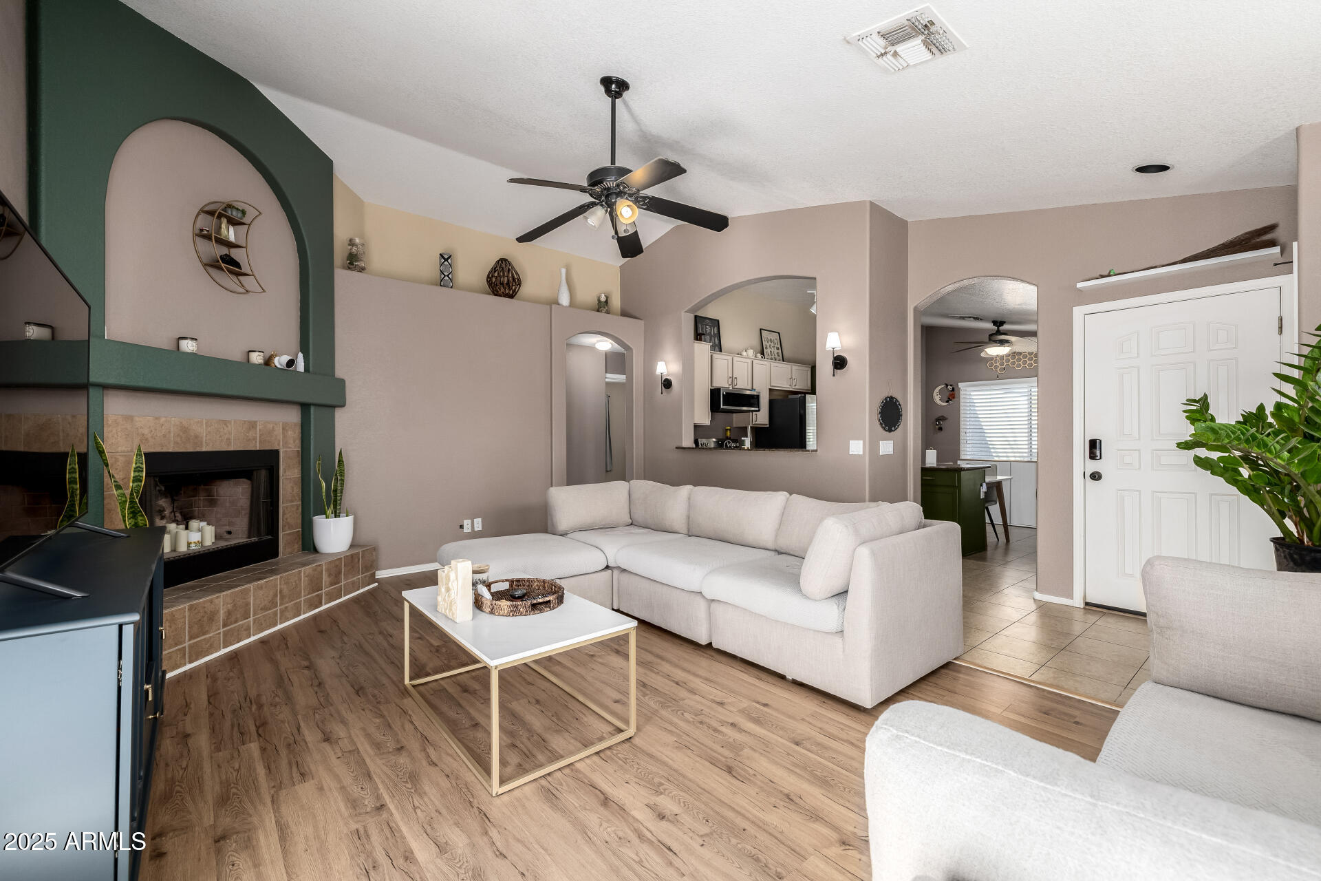 1675 East Robin Lane Gilbert, AZ 85296 - Photo 4 of 29 a living room with furniture and a fireplace