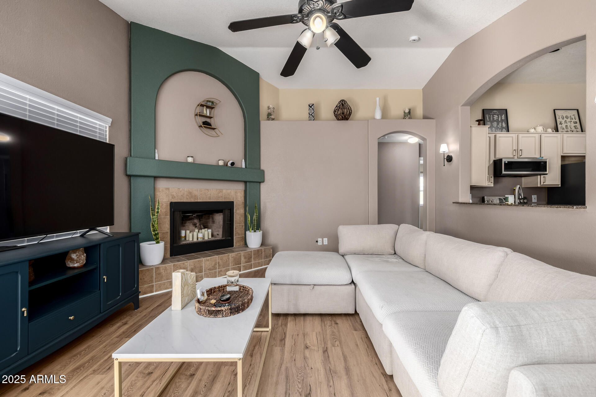 1675 East Robin Lane Gilbert, AZ 85296 - Photo 5 of 29 a living room with furniture a flat screen tv and a fireplace