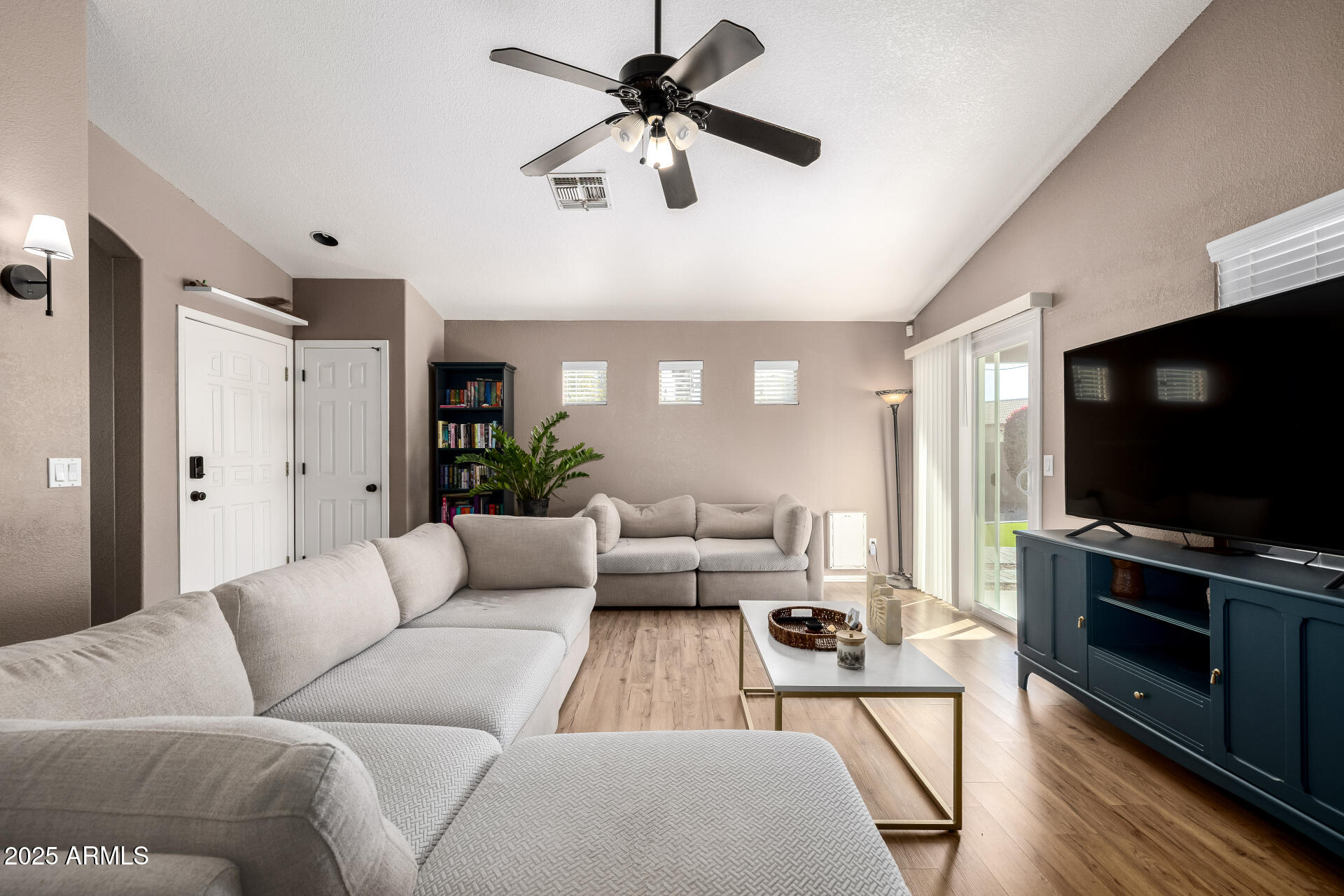 1675 East Robin Lane Gilbert, AZ 85296 - Photo 7 of 29 a living room with furniture and a flat screen tv