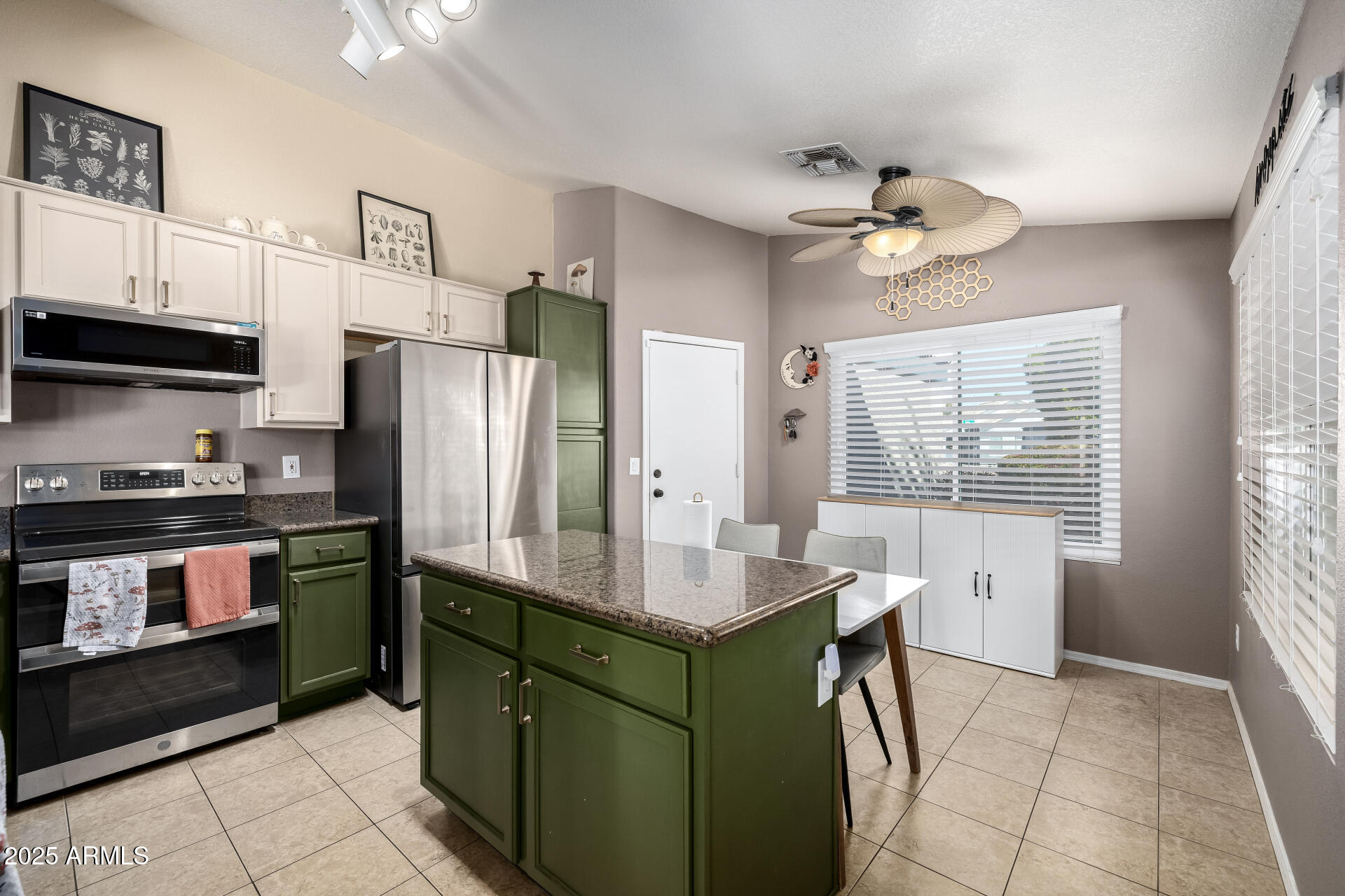 1675 East Robin Lane Gilbert, AZ 85296 - Photo 9 of 29 a kitchen with stainless steel appliances granite countertop a refrigerator a sink dishwasher a stove and a refrigerator