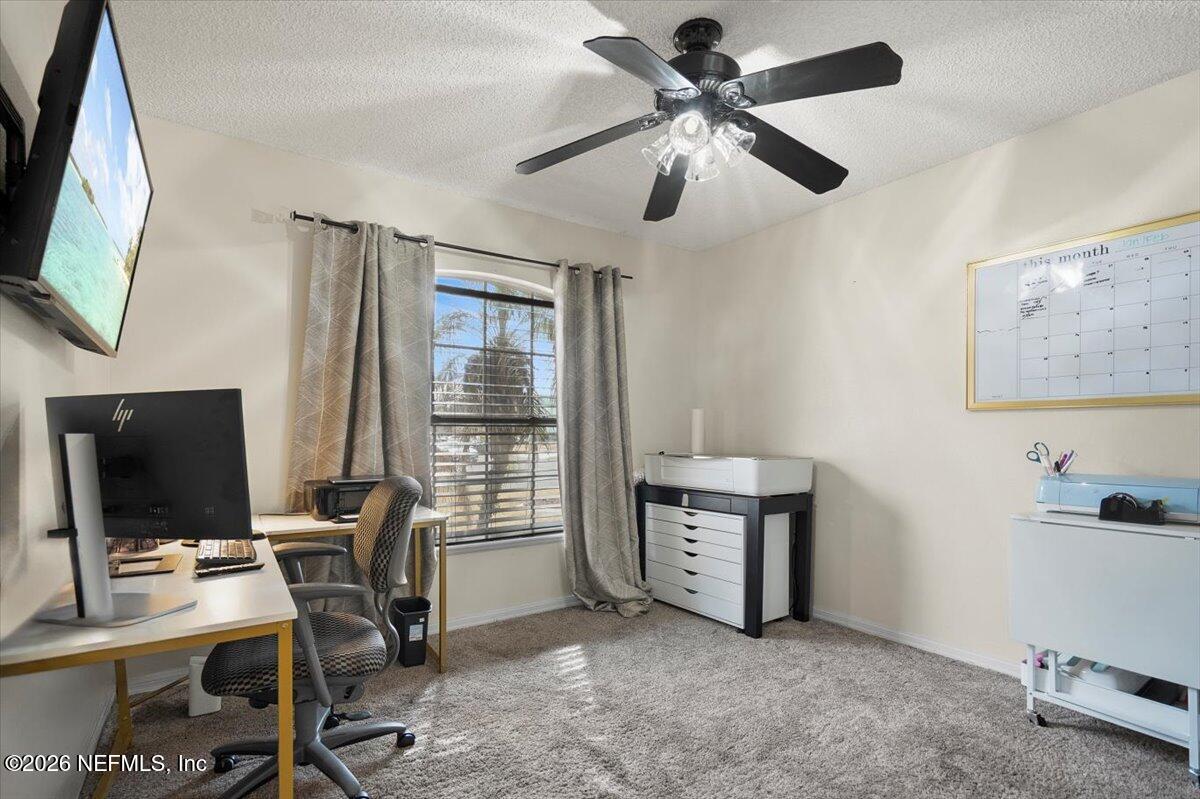 10310 Woodley Point Road Jacksonville, FL 32218 - Photo 13 of 30 a view of a workspace with furniture and a window